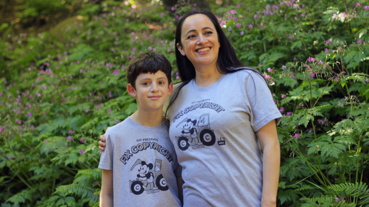 Celebrate creativity as a whole family! Child and woman wearing grey "Fix Copyright" t-shirts in a forest.