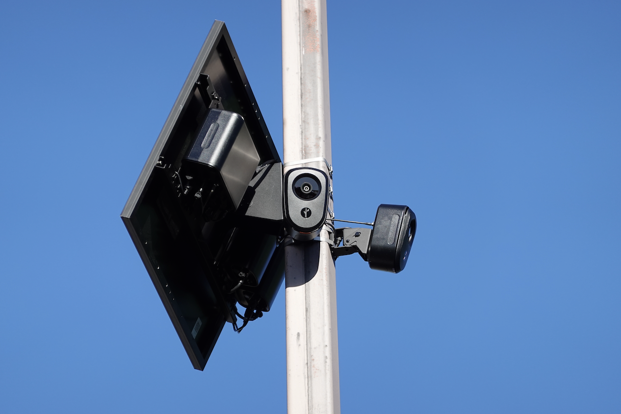 Two Flock safety cameras at 90 degrees on a pole with a solar panel Two Flock safety cameras at 90 degrees on a pole with a solar panel